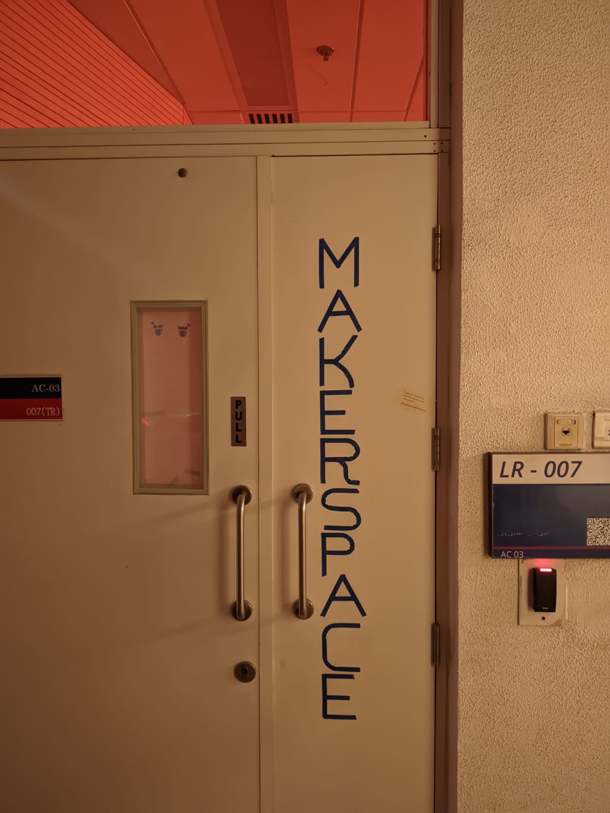 MAKERSPACE spelled out in painters tape on metal door