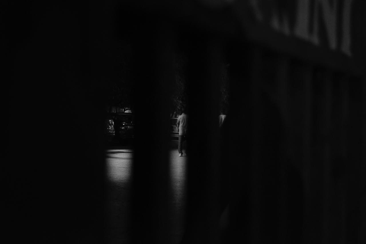Figure glimpsed through a narrow dark opening